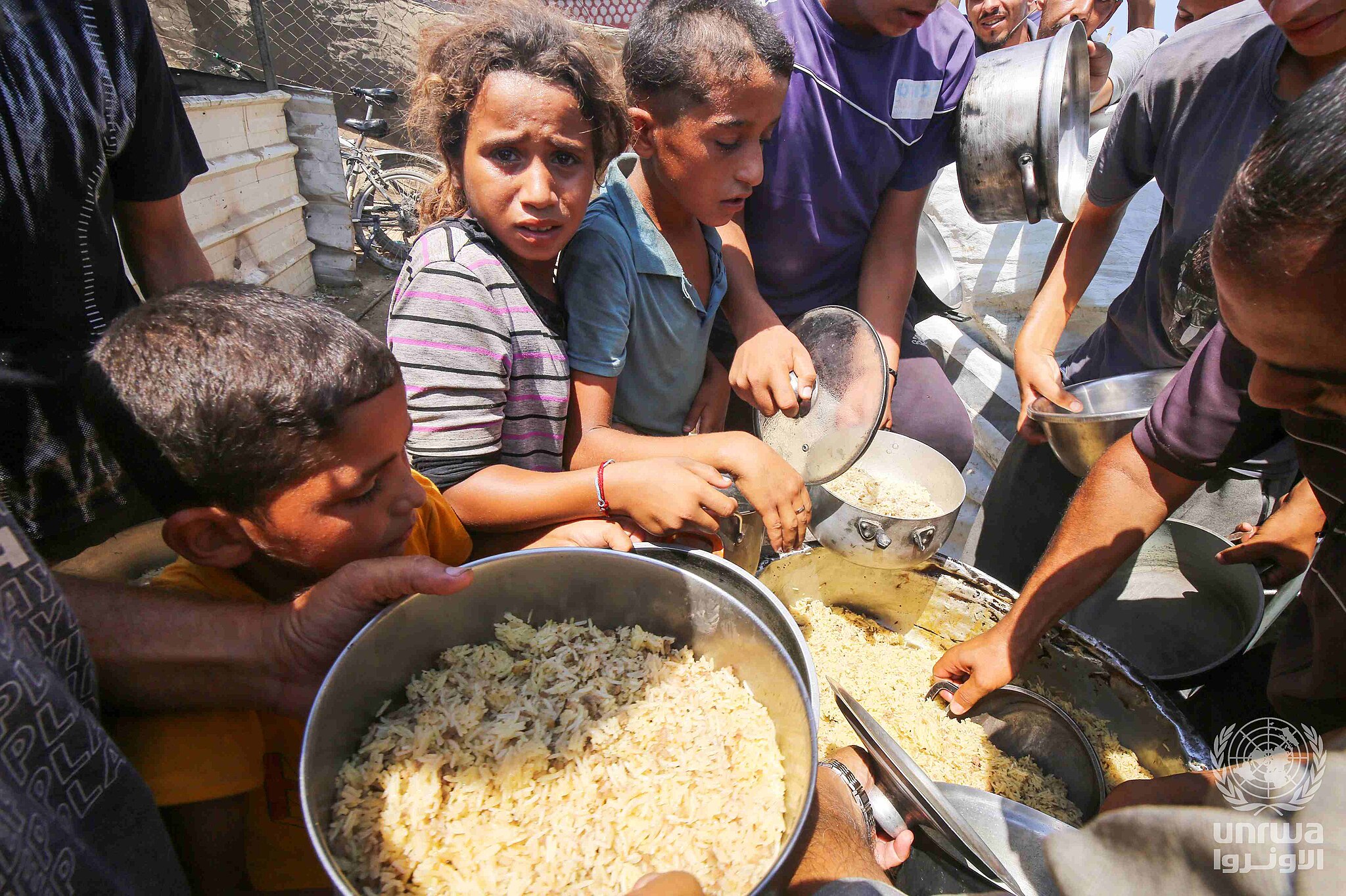 2048Px Displaced Palestinians In Deir El Balah Line Up To Receive Food Provided By Charitable Organizations