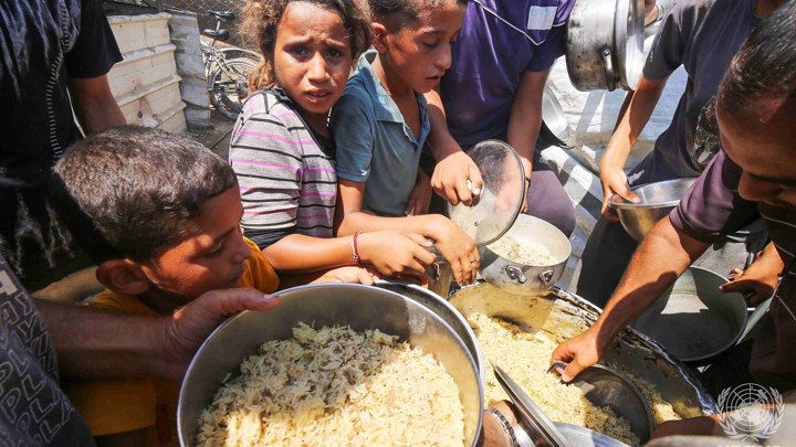 2048Px Displaced Palestinians In Deir El Balah Line Up To Receive Food Provided By Charitable Organizations